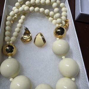 This is a vintage Monet white lucite and gold-tone bead necklace and earring set
